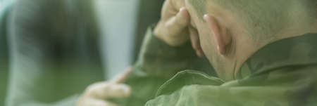 Soldier suffering from emotional breakdown and depression after warの写真素材