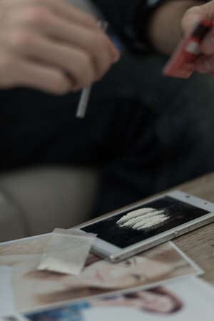 Close up of drug addict snorting cocaineの写真素材
