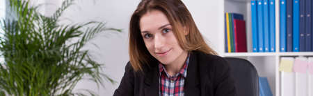 Panorama of young female office worker smiling