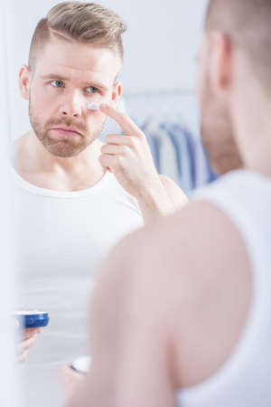 Picture of well kempt man applying face creamの写真素材