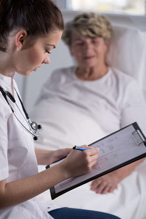 Doctor is checking her patient test resultsの写真素材