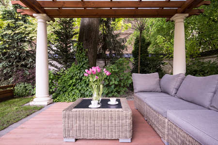Picture of relaxation space in garden with elegant rattan furniture