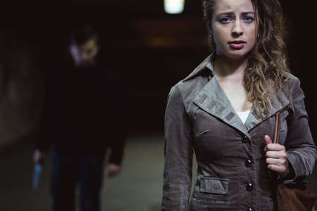 Young woman is afraid of terrible manの写真素材