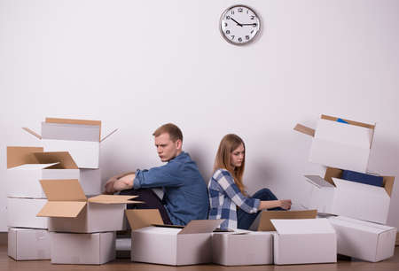 Young couple is tired because of packing up