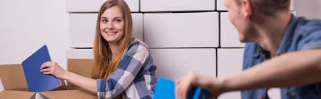 Girl is smiling to her boyfriend during packing up