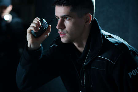 Horizontal view of police officer at actionの写真素材