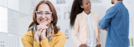 Smiling female boss working in the officeの写真素材