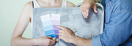 Couple choosing right color for redecorating houseの写真素材