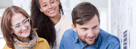 Happy male and female collaborators working together