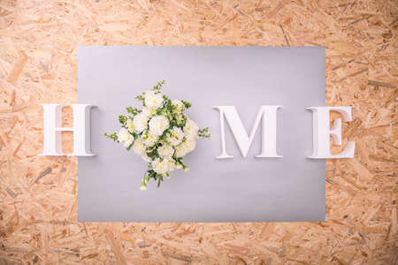 Home text on wooden background - horizontal viewの写真素材