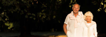 Elder man is walking around with his wifeの写真素材