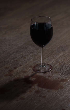 Glass full of red wine on table