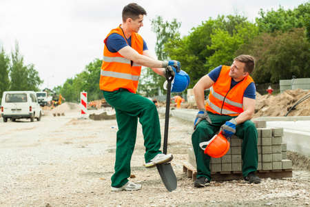 Image of two handsome construction workers having breakの写真素材