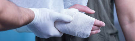 Panorama of medic giving professional help in emergency roomの写真素材