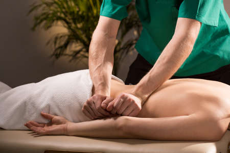 Close-up of physical therapist doing medical massageの写真素材