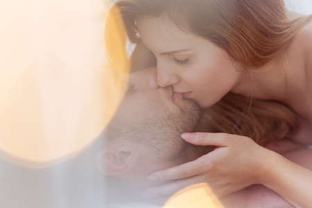 Close-up of attractive amorous couple kissing tenderlyの写真素材