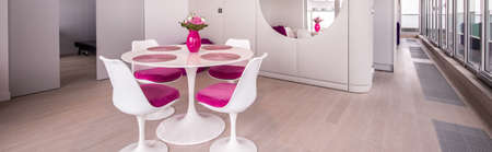Panorama of white round stylish table and elegant chairsの写真素材