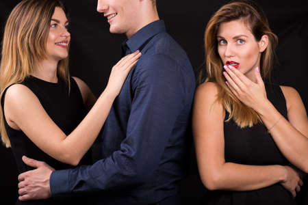 Two young sexy women in black dressの写真素材