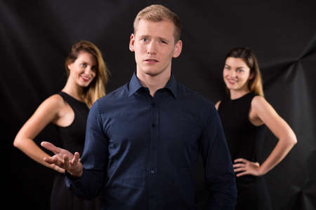 Picture of two women seducing handsome manの写真素材