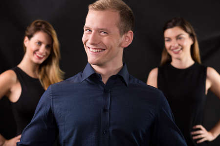 Handsome lovelace surrounded by two beauty womanの写真素材