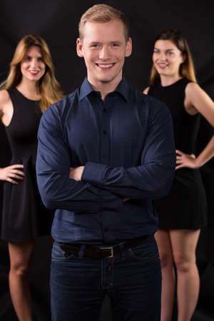 Vertical view of womanizer and two beauty ladiesの写真素材