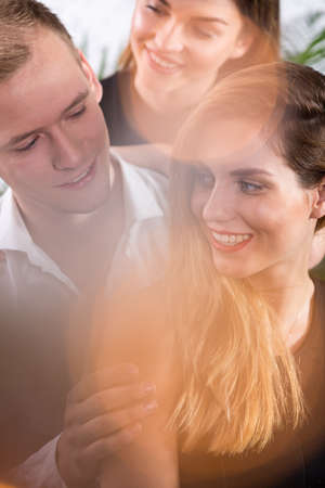 Three people flirting together - romance triangle conceptの写真素材