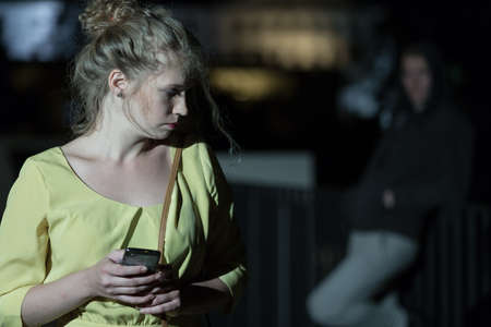 Young woman wants to call the policeの写真素材