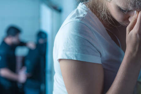 Young and scared woman is released by a policemanの写真素材
