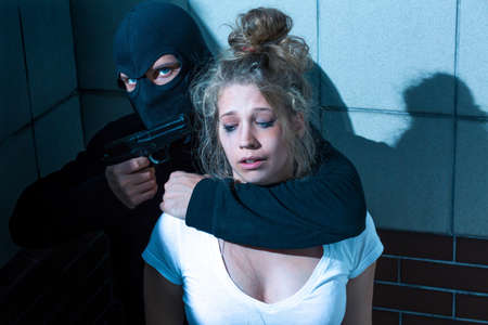 Gunman is threatening to kill the womanの写真素材
