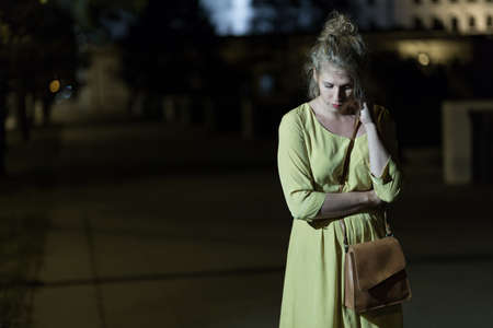 Lonely young woman is very scared at nightの写真素材