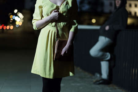 Young woman is afraid of strong manの写真素材