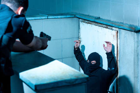 Dangerous man is surrendering to the policemanの写真素材