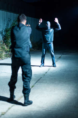 Police officer is pointing to the criminalの写真素材