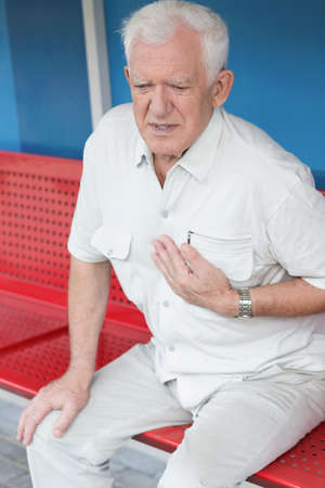 Man having heart attack on the bus stopの写真素材