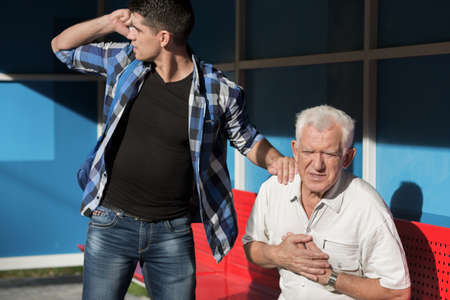 Man with heart disease and caring grandsonの写真素材