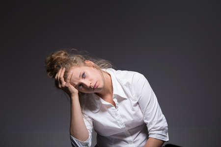 Photo of exhausted woman having a crisis at workの写真素材