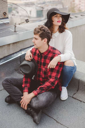 Hipster couple having date on the roofの写真素材