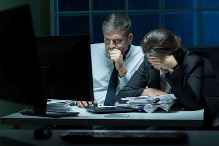 Overworked employees working at night in the office