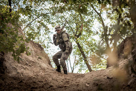 Horizontal view of hunter in the forestの写真素材