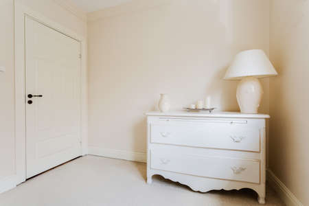 Close up of wooden vintage commode standing in bright roomの写真素材