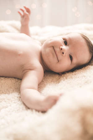 Picture of content baby lying with arms open