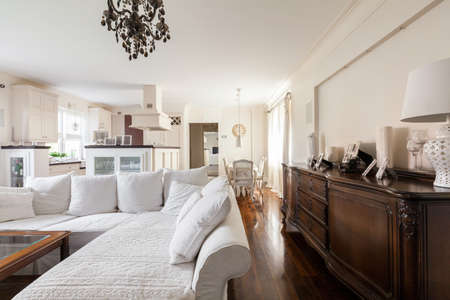 Photo of bright living room with antique cabinet