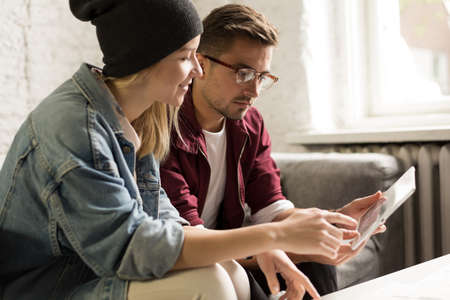Cheerful woman and handsome man using the tabletの写真素材