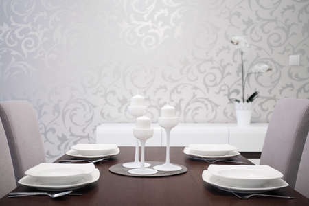 Elegantly prepared dining table with white table settingの写真素材