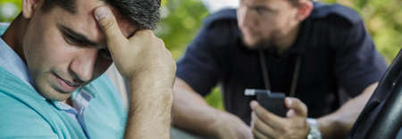 Young man was driving after drinking alcoholの写真素材