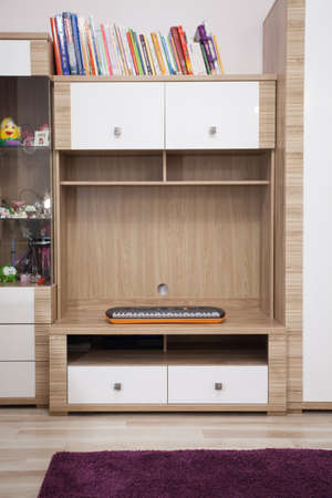 Keyboard on wooden shelf in modern study roomの写真素材