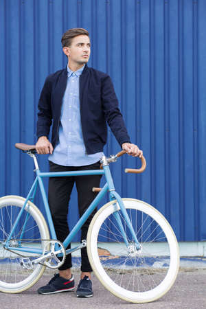 Active businessman commuting to work by bikeの写真素材