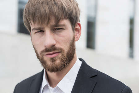 Portrait of young handsome man in black suit
