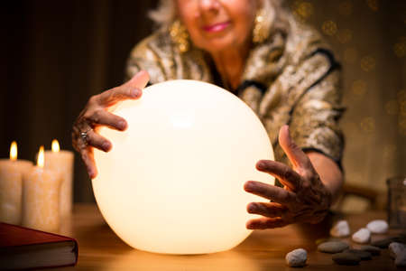 Close-up of magic woman with crystal ballの写真素材