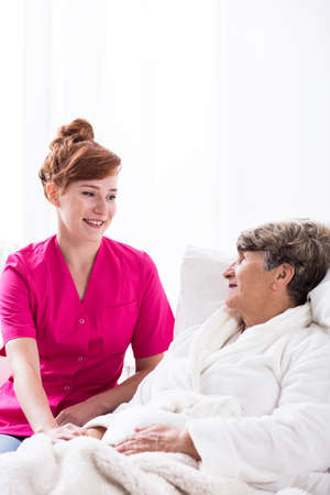 Image of professional carer and elderly female patientの写真素材